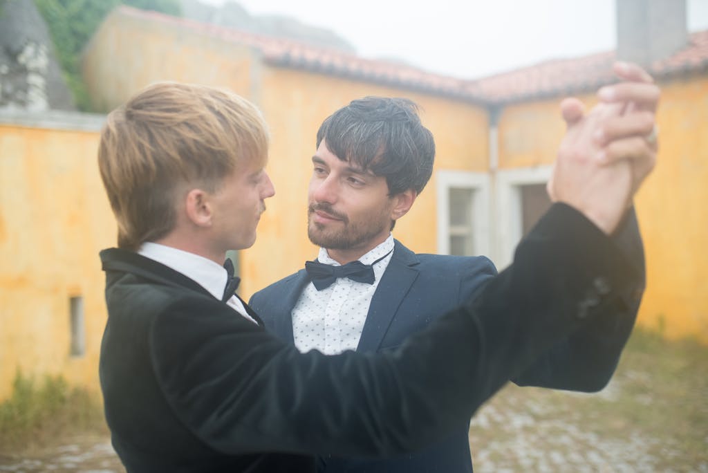 A couple sharing a dance in an outdoor courtyard, showcasing love and connection.